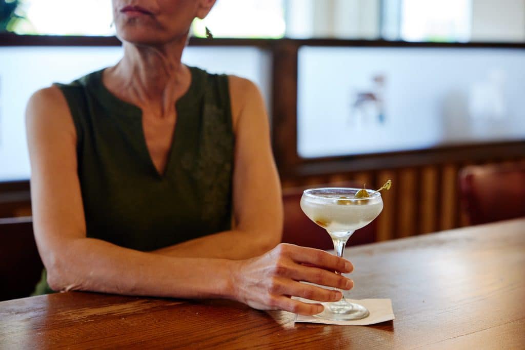 Woman holding a drink at a bar