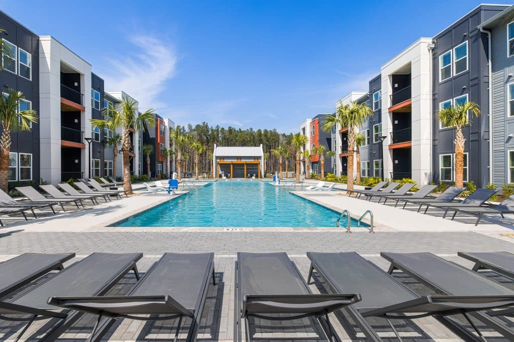 Large community pool and ample deck seating at The Ames