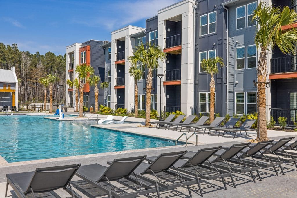 Palm trees and ample seating surrounding The Ames' community pool