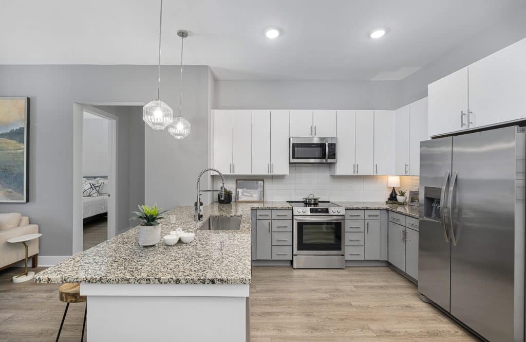 Modern apartment kitchen with stainless steel appliances in homes at The Ames